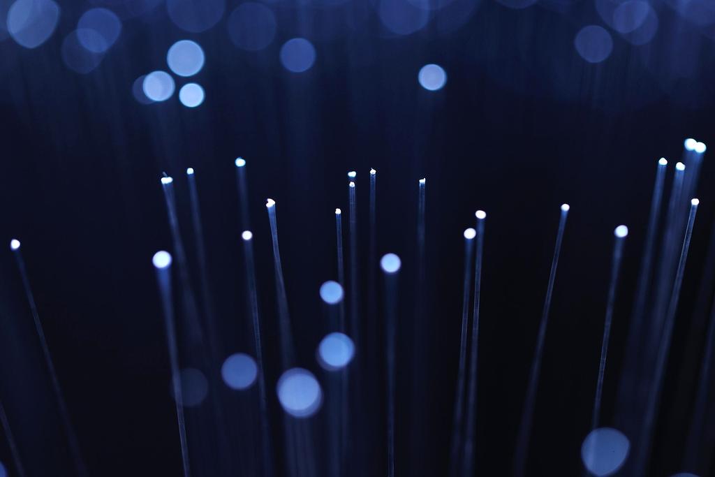 Close up of fiber optic cables glowing blue